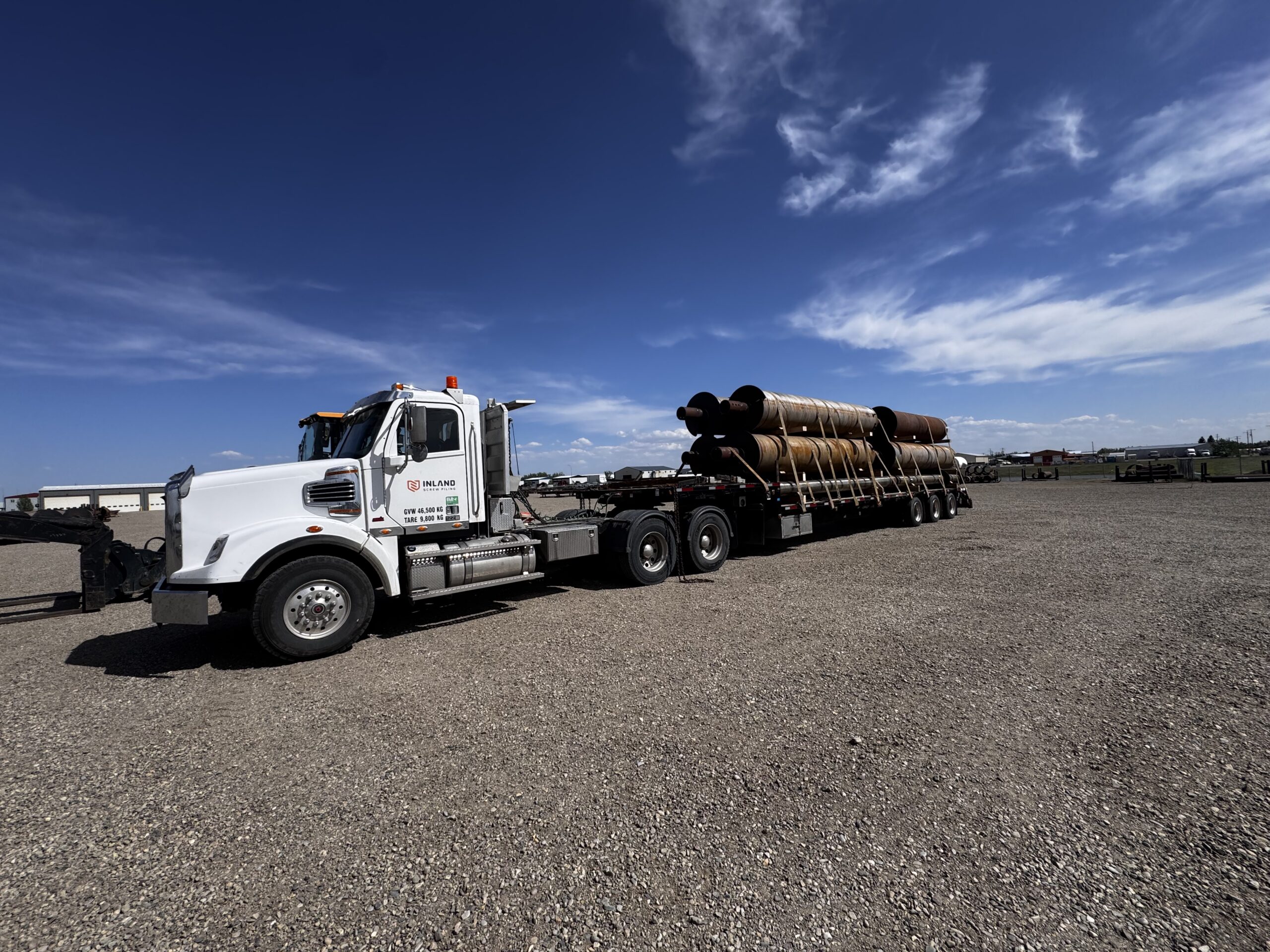 Inland Screw Piling truck loaded with True Pitch screw piles for delivery to a Calgary-area project